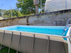 a hot tub with a fence around it at Casa Romai Portas in Romay