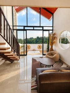 a living room with a couch and a table at Villa With Jacuzzi, Damar Ningrum 3 in Tutugan