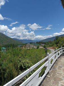 a white fence with a view of a mountain at Drukyul Kora Tours & Treks in Thimphu