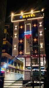 a hotel with a sign on the front of it at night at Hotel Pohor Regency 10 minutes travel to Kamakhya Temple in Guwahati