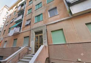 an apartment building with stairs in front of it at Pineta Holiday Home in Genoa