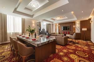 a hotel lobby with a long bar and chairs at Van Phat Riverside Hotel in Can Tho