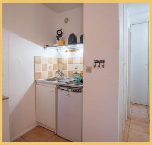 a small kitchen with a sink and a stove at Chez Sebastien I Studio I Bernex in Bernex +12 photos