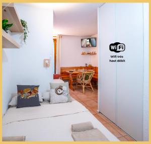 a room with two beds and a dining room at Chez Sebastien I Studio I Bernex in Bernex