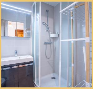 a bathroom with a glass shower and a sink at Chez Sebastien I Studio I Bernex in Bernex