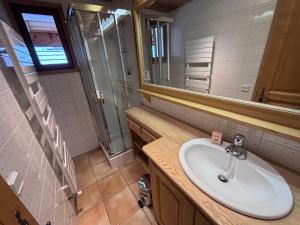 a bathroom with a sink and a mirror at La chambre Chez Marion 2 personnes in Notre-Dame-de-Bellecombe