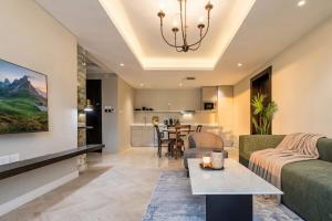 a living room with a couch and a table at Stella Stays Olaya Tower 1 - Furnished Apartments in Riyadh