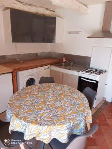 a kitchen with a table and chairs in a room at house in Saint-André-des-Eaux