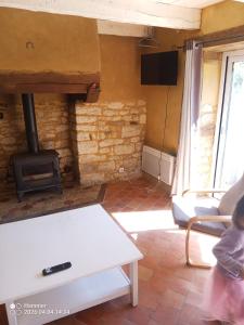 a living room with a stove and a couch at house in Saint-André-des-Eaux