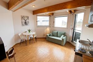 a living room with a table and a chair at Boardinghouse Steinen in Steinen