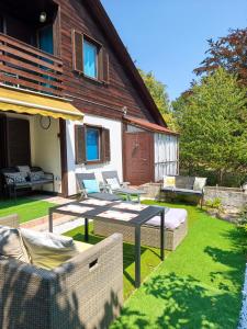 a backyard with a table and chairs and a house at Buda Weekend House in Budapest