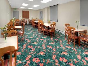 a room with tables and chairs with flowers on the floor at The Monarch Hotel in San Francisco