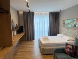 a bedroom with a bed and a couch and a window at SD House in Vlorë +31 photos