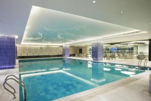 a large swimming pool in a hotel building at Datong Hotel in Datong