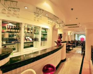 a bar in a restaurant with a counter and chairs at Datong Hotel in Datong