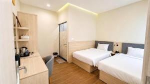 a hotel room with two beds and a window at New Star Hotel Tay Ninh in Tây Ninh +61 photos