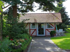 a small red and white shed with a porch at Gästehaus Mayer-Bartsch in Meersburg