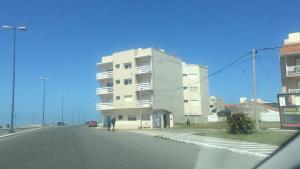 a man walking down a street next to a building at Departamento Bellavista Frente al Mar in Miramar