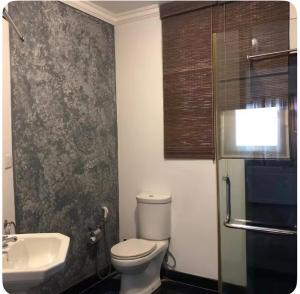 a bathroom with a toilet and a sink at Moratuwa suburban oasis in Moratuwa