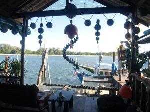 a boat on the water with balloons hanging from a dock at Peacock Hostel in Ko Lanta +30 photos