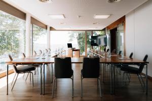 a conference room with wooden tables and chairs at Vogelsburg in Volkach