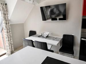 a dining room with a white table and chairs at Medius Park Apartment in Sandanski