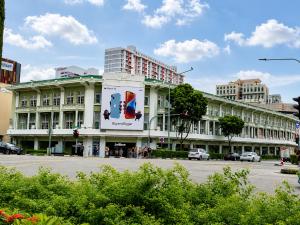 a large white building with a large sign on it at A Hotel Bugis Village in Singapore
