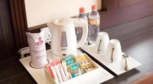 a hotel room table with a coffee maker and complimentary items at Devon Hotel in Kandy
