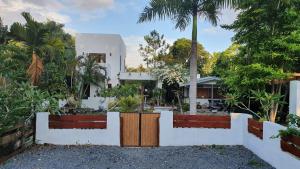 a house with a gate in front of a yard at dilo tree lodge in Sigatoka