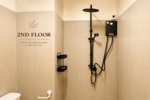 a bathroom with a shower with a toilet at Dad N Mom's House By Thongnak Apartment in Pattaya +50 photos