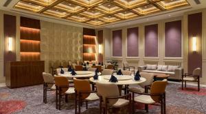 a meeting room with tables and chairs in a building at Lumeirrah Suites in Moga