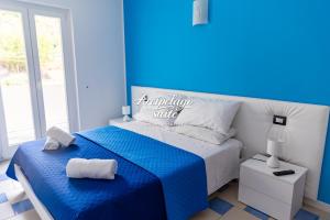 a blue and white bedroom with a blue and white bed at Arcipelago Suite in Belvedere Marittimo