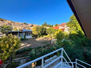 a view of a garden from the balcony of a house at Kaplan Apart - Pansiyon in Yeşilova