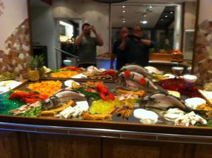 two men taking pictures of a buffet of food at Hotel-Restaurant Bürgerstuben in Lebach