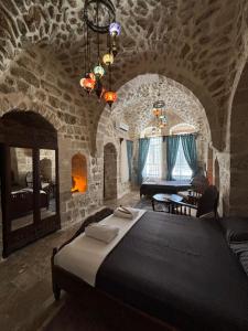 a bedroom with a large bed in a stone room at Kasri Reyyan in Mardin