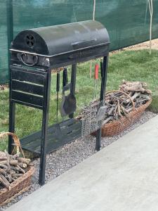 a black stove sitting next to a basket of wood at Ugam Glamping in Khumson