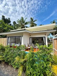 a small white house with trees in the background at Srithanu Escape 2 in Srithanu