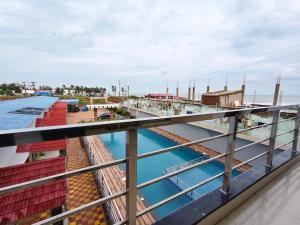 a view of the water from the balcony of a building at Sea Wander Beach Resort in Mandarmoni