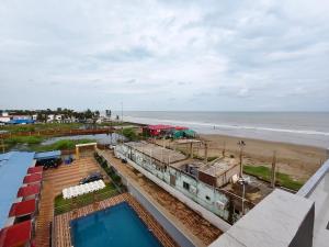 a view of the beach and the ocean from a building at Sea Wander Beach Resort in Mandarmoni