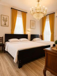 a bedroom with a large bed with a chandelier at Four seasons in Kutaisi