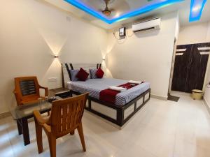 a bedroom with a bed and a desk and a chair at Sea Wander Beach Resort in Mandarmoni