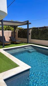 a swimming pool in front of a house at Vei Estate in Schinias