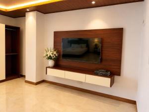 a living room with a large flat screen tv on a wall at Bravon Sky Hotel in Kurunegala