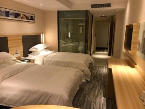 Rúm í herbergi á Hotel Pomelo Premier 西柚臻选武昌站酒店