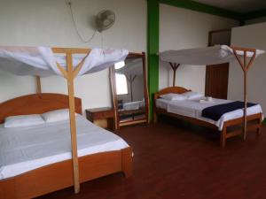 Postel nebo postele na pokoji v ubytování Tambopata Hostel