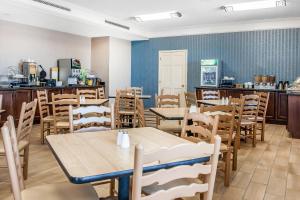 a dining room with wooden tables and chairs at Quality Inn Findlay in Findlay