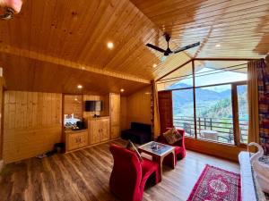 a living room with a view of a mountain at Hotel Mount Manali - The Cozy Stay in Vashisht +20 photos