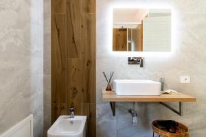 a bathroom with a sink and a toilet at Comfyrooms in Quartu SantʼElena