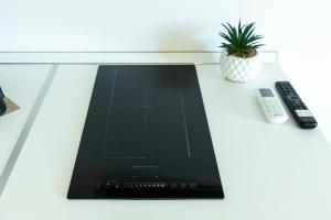 a tablet computer sitting on a table with a remote control at Comfyrooms in Quartu SantʼElena