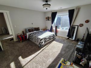 a bedroom with a bed and a window at Evergreen House in Vancouver